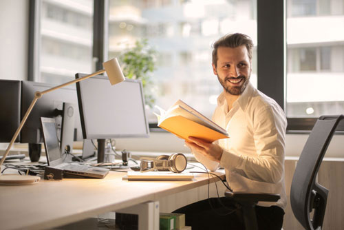 smiling businessman reading office documents