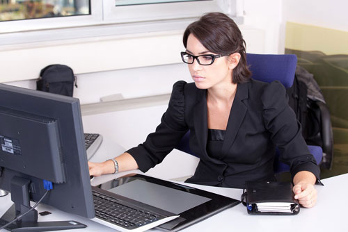 businesswoman working at desktop computer