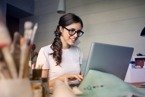 smiling woman working on laptop