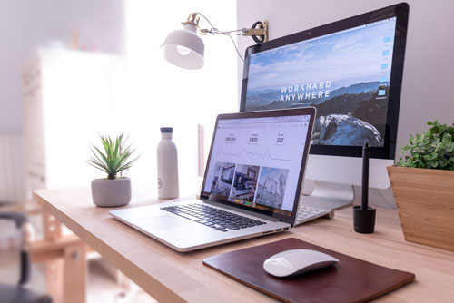 minimalist workspace with laptop and monitor
