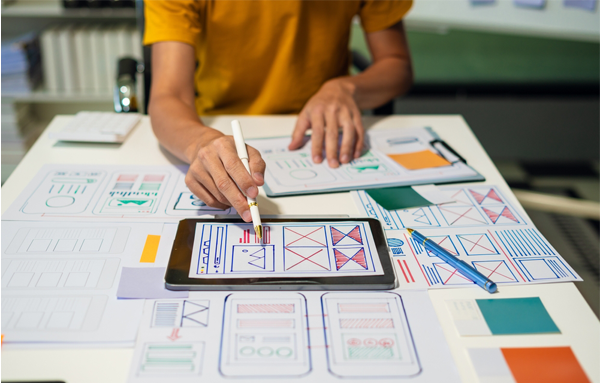 designer creating app wireframes on tablet